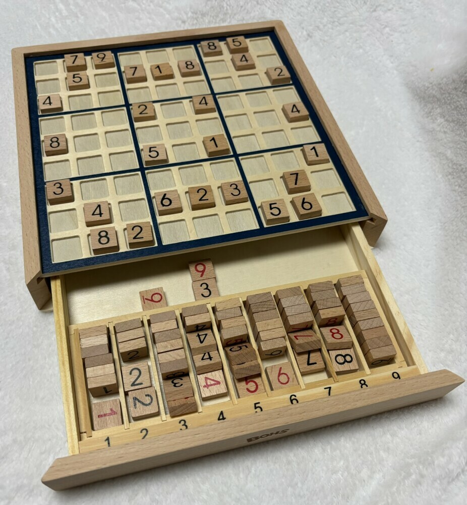 Picture of BOHS wooden sudoku board game set with drawer open to see how it holds tiles